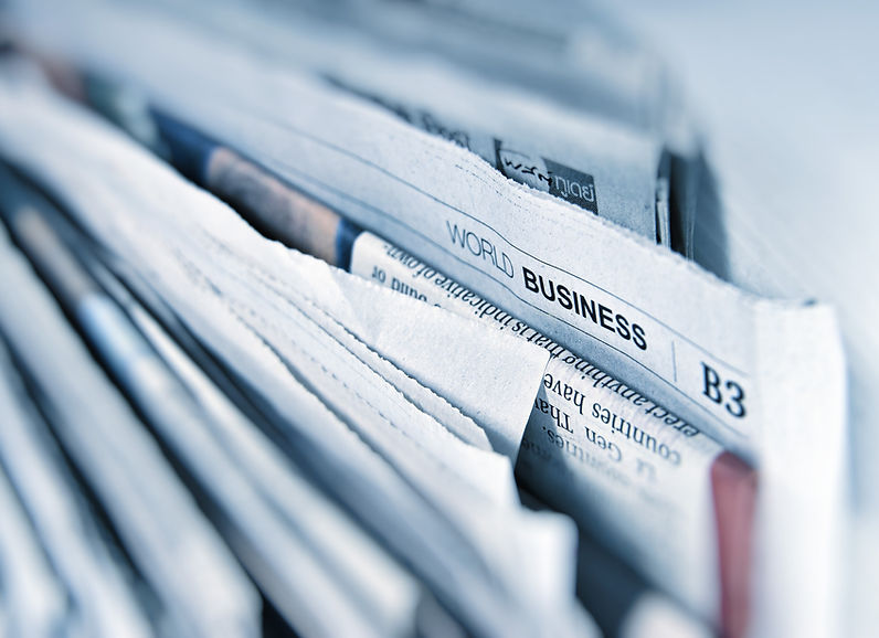 Newspapers spread across a table